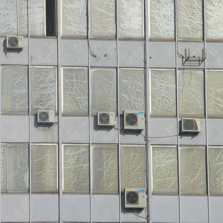 building facade with scratched windows and air conditioners